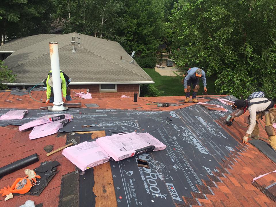 workers installing a new roof in MN